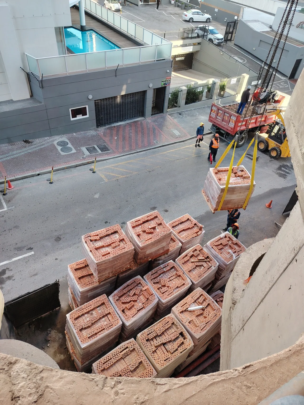 Materials being lifted into the active construction site